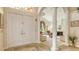 Elegant foyer featuring double doors, decorative columns, and a glimpse into the bright and airy living room at 4221 Escondito Cir, Sarasota, FL 34238