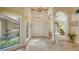 Elegant foyer with marble floors, arched doorway, and courtyard view filled with natural light at 4221 Escondito Cir, Sarasota, FL 34238