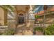 Elegant front entrance with double doors, stately columns, and lush landscaping details at 4221 Escondito Cir, Sarasota, FL 34238