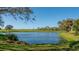 Scenic view of a golf course and lake in a beautifully landscaped setting at 4221 Escondito Cir, Sarasota, FL 34238