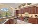 Spacious kitchen features custom cabinetry, granite countertops, and stainless steel appliances at 4221 Escondito Cir, Sarasota, FL 34238