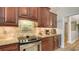 Gourmet kitchen with updated cabinets, tile backsplash, and granite countertops at 4221 Escondito Cir, Sarasota, FL 34238