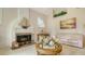 Living room featuring a fireplace, vaulted ceilings, and neutral decor at 4221 Escondito Cir, Sarasota, FL 34238