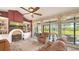 Cozy living room with a fireplace, built-in shelving, and a view of the pool and backyard at 4221 Escondito Cir, Sarasota, FL 34238