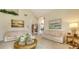 Spacious living room with neutral walls and floors, with art on walls and view into next room at 4221 Escondito Cir, Sarasota, FL 34238