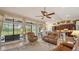 Inviting living room with a view of the backyard, high ceilings, and ceiling fan at 4221 Escondito Cir, Sarasota, FL 34238