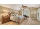 Elegant main bedroom with vaulted ceiling, plantation shutters, and wood-look floors at 4221 Escondito Cir, Sarasota, FL 34238
