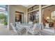 Covered patio with a dining set and seating area, perfect for outdoor dining and entertaining guests at 4221 Escondito Cir, Sarasota, FL 34238