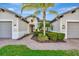 Welcoming front exterior with a manicured lawn, complemented by a brick path leading to the entrance and a three-car garage at 5607 Tidewater Preserve Blvd, Bradenton, FL 34208