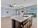 Modern kitchen island featuring a sink and pendant lighting, perfect for entertaining and meal preparation at 5607 Tidewater Preserve Blvd, Bradenton, FL 34208