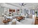 Spacious living room featuring a large sectional sofa, open concept kitchen and contemporary decor at 5607 Tidewater Preserve Blvd, Bradenton, FL 34208