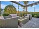 Outdoor patio features a fire pit and lounge seating, perfect for relaxing and enjoying the scenery at 5607 Tidewater Preserve Blvd, Bradenton, FL 34208