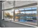 Tranquil view of the pool and lanai from the window, creating a relaxing and inviting atmosphere at 5607 Tidewater Preserve Blvd, Bradenton, FL 34208