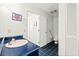 Bright bathroom showcases blue tile flooring, a toilet, vanity, and a full-sized mirror at 5724 Doral Dr, Sarasota, FL 34243