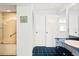 Bright bathroom featuring a shower/tub combination, tiled floor, storage cabinets, and a sink at 5724 Doral Dr, Sarasota, FL 34243