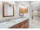 Well-lit bathroom with dual sinks, granite countertops and access to a bathtub at 5724 Doral Dr, Sarasota, FL 34243