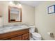 Clean bathroom with a granite countertop, single sink, and a white toilet at 5724 Doral Dr, Sarasota, FL 34243