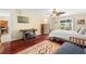 Serene bedroom with hardwood floors, a ceiling fan, and a sliding glass door to the patio at 5724 Doral Dr, Sarasota, FL 34243