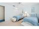 Comfortable bedroom showcases two beds, a ceiling fan, and a closet for storage at 5724 Doral Dr, Sarasota, FL 34243