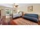 Cozy bedroom with wood floors, ceiling fan, and sliding glass door to the outdoors at 5724 Doral Dr, Sarasota, FL 34243