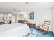 Bright bedroom featuring white comforter, and sitting area at 5724 Doral Dr, Sarasota, FL 34243