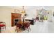 Dining area with a fireplace, an antique table, and views of the outdoors at 5724 Doral Dr, Sarasota, FL 34243