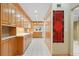 Spacious kitchen featuring wooden cabinetry and white tile flooring at 5724 Doral Dr, Sarasota, FL 34243