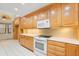 Kitchen featuring wooden cabinetry, a white countertop and stainless steel appliances at 5724 Doral Dr, Sarasota, FL 34243