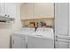 Efficient laundry room with washer, dryer, and ample storage space at 5724 Doral Dr, Sarasota, FL 34243
