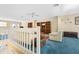 Spacious living room showcasing plush blue carpet, ceiling fan, built-in bookshelves, and comfortable seating at 5724 Doral Dr, Sarasota, FL 34243