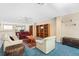 Expansive living room highlighting built-in bookshelves, two sofas, area rug, and an eye-catching ceiling fan at 5724 Doral Dr, Sarasota, FL 34243