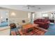Comfortable living area featuring two couches, a ceiling fan, an area rug, and natural light at 5724 Doral Dr, Sarasota, FL 34243
