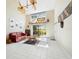 Bright living room featuring high ceilings, tile flooring, and sliding glass doors at 5724 Doral Dr, Sarasota, FL 34243