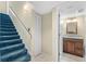 Carpeted staircase leads to a hallway with a bathroom featuring a granite vanity and a closet for storage at 5724 Doral Dr, Sarasota, FL 34243