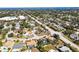 An aerial view of a residential area featuring mature trees, various home styles, and blue ocean in the background at 7507 3Rd Nw Ave, Bradenton, FL 34209