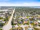 Panoramic aerial view of a residential area with tree-lined streets, shopping, and a distant view of the bay at 7507 3Rd Nw Ave, Bradenton, FL 34209