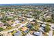 Aerial view of a residential area with mature trees, green lawns, and inviting swimming pools in a tranquil location at 7507 3Rd Nw Ave, Bradenton, FL 34209