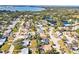 This aerial view displays a peaceful neighborhood with lake access, mature trees, and diverse housing options at 7507 3Rd Nw Ave, Bradenton, FL 34209