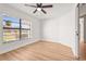 Bedroom showcasing new flooring, a large window, and a ceiling fan at 7507 3Rd Nw Ave, Bradenton, FL 34209
