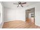 Bedroom showcasing new flooring, an open doorway, and a ceiling fan at 7507 3Rd Nw Ave, Bradenton, FL 34209