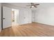 Spacious bedroom has wood-look flooring, a ceiling fan, and ensuite bathroom at 7507 3Rd Nw Ave, Bradenton, FL 34209