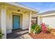 Inviting front entrance with a bright-colored door, decorative plants, and modern lighting at 7507 3Rd Nw Ave, Bradenton, FL 34209