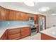 This kitchen features beautiful wood cabinets, stainless steel appliances, tile backsplash, and light countertops at 7507 3Rd Nw Ave, Bradenton, FL 34209