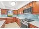 Updated kitchen features beautiful wood cabinets, stainless steel appliances, tile backsplash, and light countertops at 7507 3Rd Nw Ave, Bradenton, FL 34209