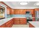 Updated kitchen features beautiful wood cabinets, stainless steel appliances, tile backsplash, and light countertops at 7507 3Rd Nw Ave, Bradenton, FL 34209