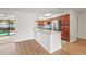 Stylish kitchen with granite countertops, modern appliances, and views of the living room and pool at 7507 3Rd Nw Ave, Bradenton, FL 34209