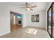 Spacious living room features tile floors, a ceiling fan, and an open layout with views of the fireplace at 7507 3Rd Nw Ave, Bradenton, FL 34209