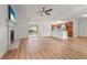 Bright, open living room with a fireplace, ceiling fan and hardwood flooring that flows to the kitchen at 7507 3Rd Nw Ave, Bradenton, FL 34209