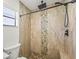 Close-up view of the stone shower with pebble accents at 7507 3Rd Nw Ave, Bradenton, FL 34209