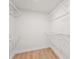Spacious walk-in closet with wire shelving and wood-look floors at 7507 3Rd Nw Ave, Bradenton, FL 34209
